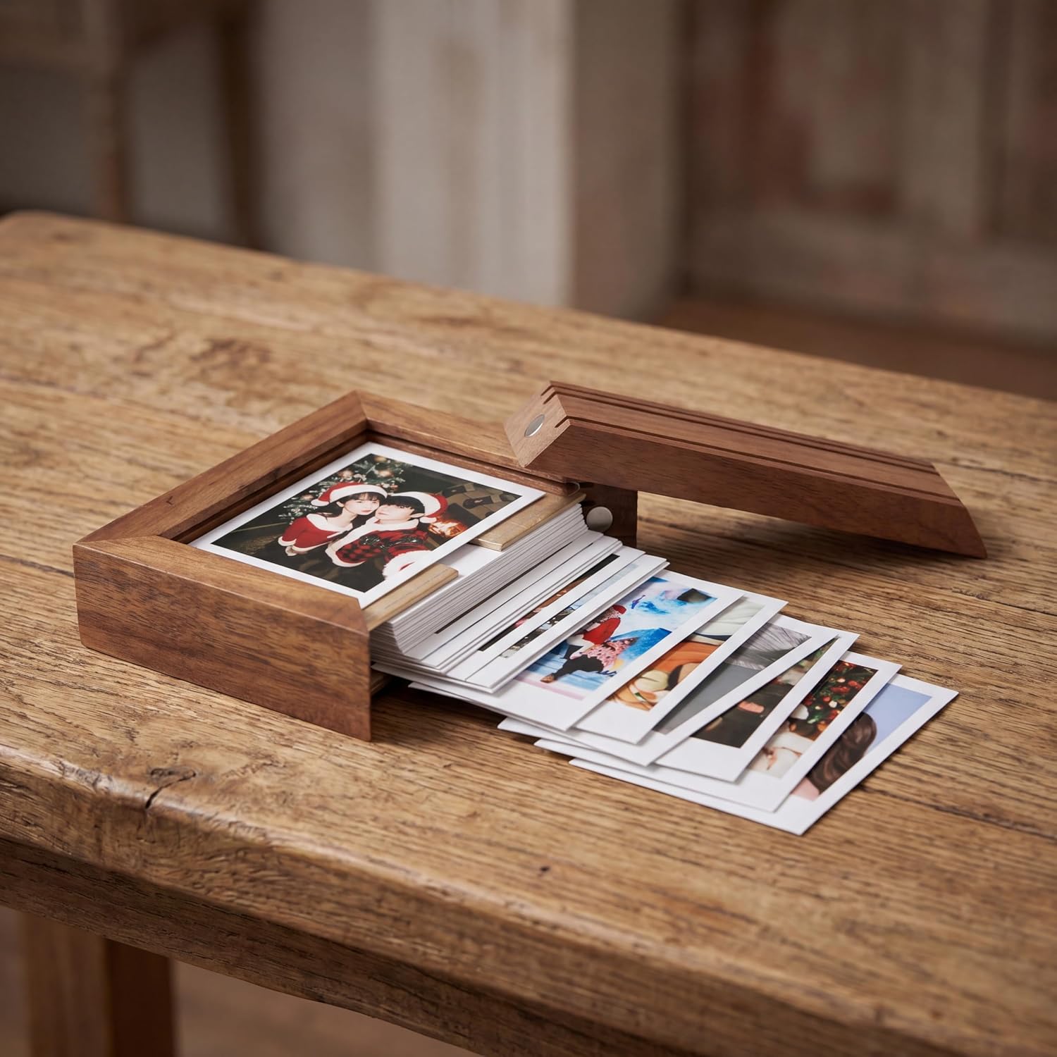 Wooden photo box with photographs on a table