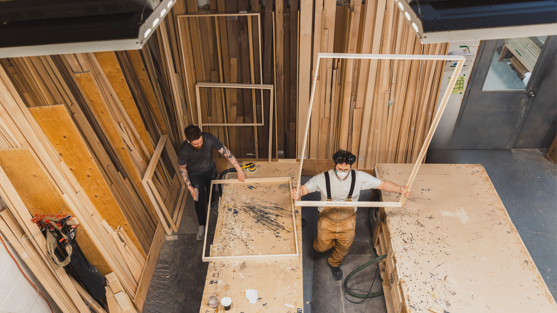 Two Good Frame craftspeople making timber frames in the workshop